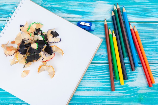 Pencils, pencil cuts and blank paper on a desk table