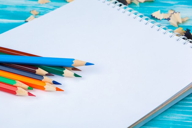 Pencils, pencil cuts and blank paper on desk table