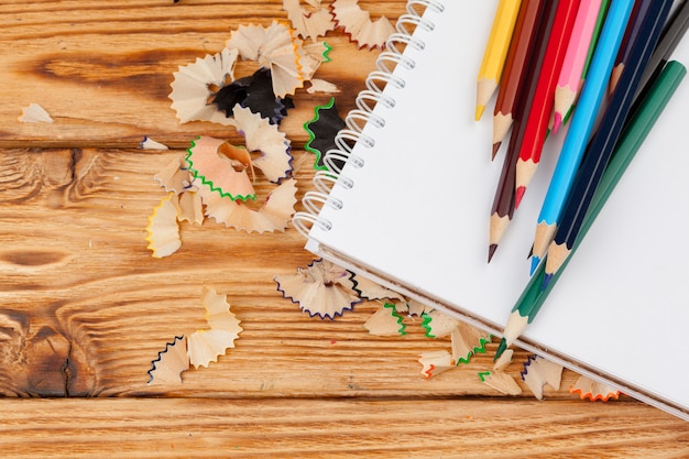 Pencils, pencil cuts and blank paper on a desk table