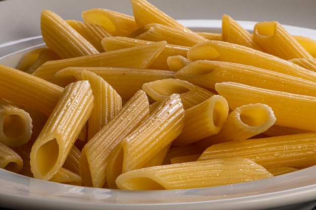 Penne noodles served in butter on a white plate