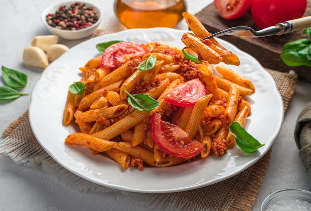 Penne pasta with bolognese sauce close-up. Side view, close-up. Italian cuisine.