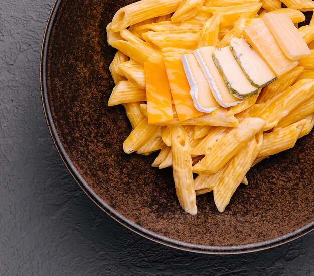 penne pasta with cheese on top view