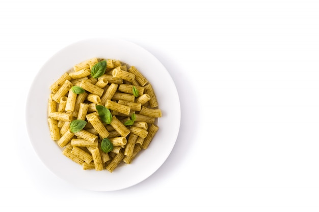 Penne pasta with pesto sauce and basil on a plate isolated on white