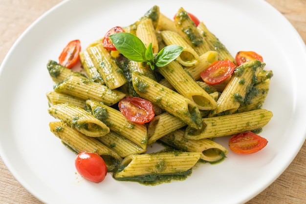 penne pasta with pesto sauce and tomatoes - vegan and vegetarian food style