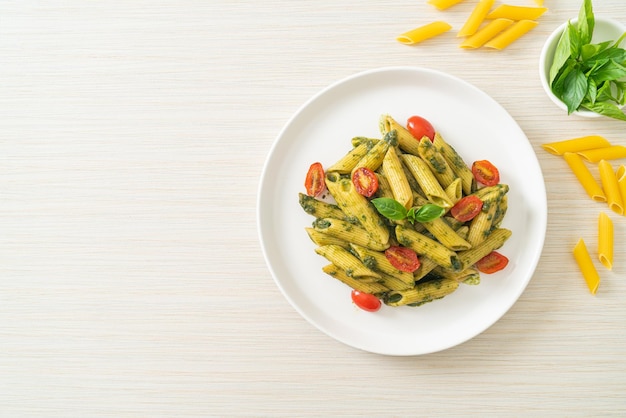 Penne pasta with pesto sauce and tomatoes