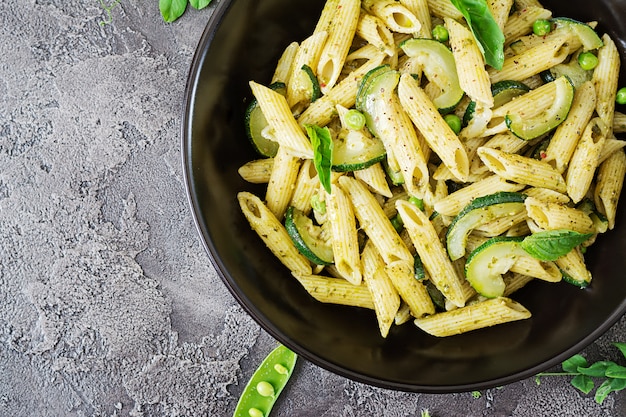 Penne al pesto, zucchine, piselli e basilico. cibo italiano.