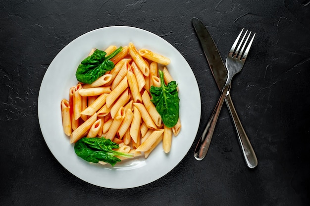 Penney pasta in tomato sauce on concrete background