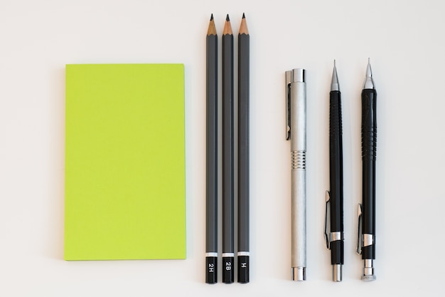 Photo pens and office supplies arranged in simplistic manner