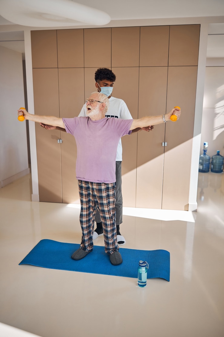 फोटो pensioner working out with his fitness instructor