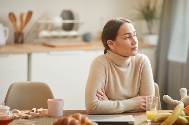 Pensive Adult Woman in Home Interior