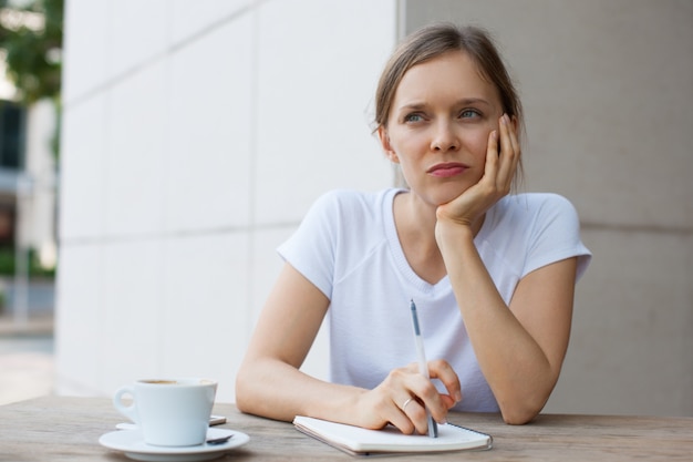 Pensive Attractive Woman Working in Outdoor Cafe