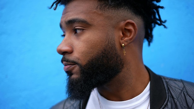 A pensive black man face closeup thinking