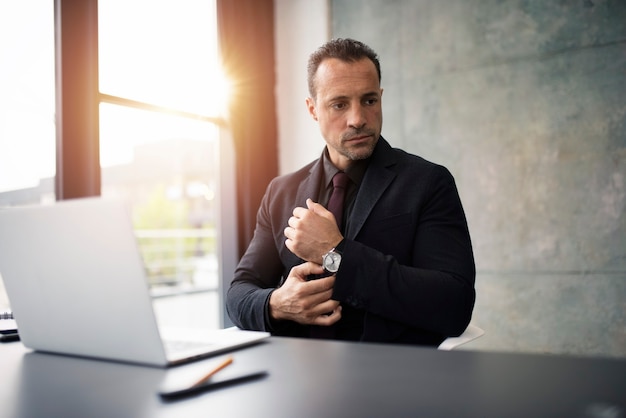 Pensive businessman working with a laptop in office