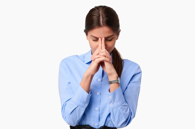 Pensive businesswoman in blue shirt on white isolated background