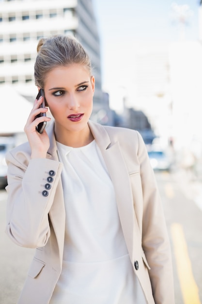 Pensive gorgeous businesswoman having a phone call