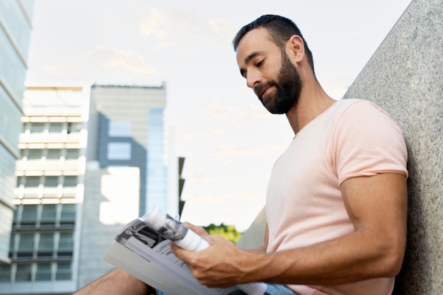 Pensive latin student studying, reading book sitting in university campus, education concept.