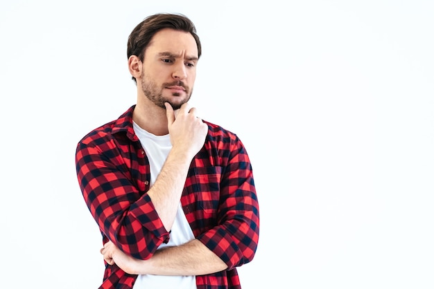 The pensive man standing on the white background