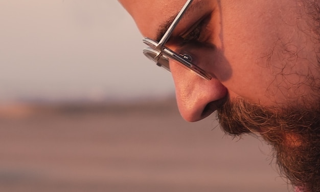 Pensive man in sunglasses and with a beard