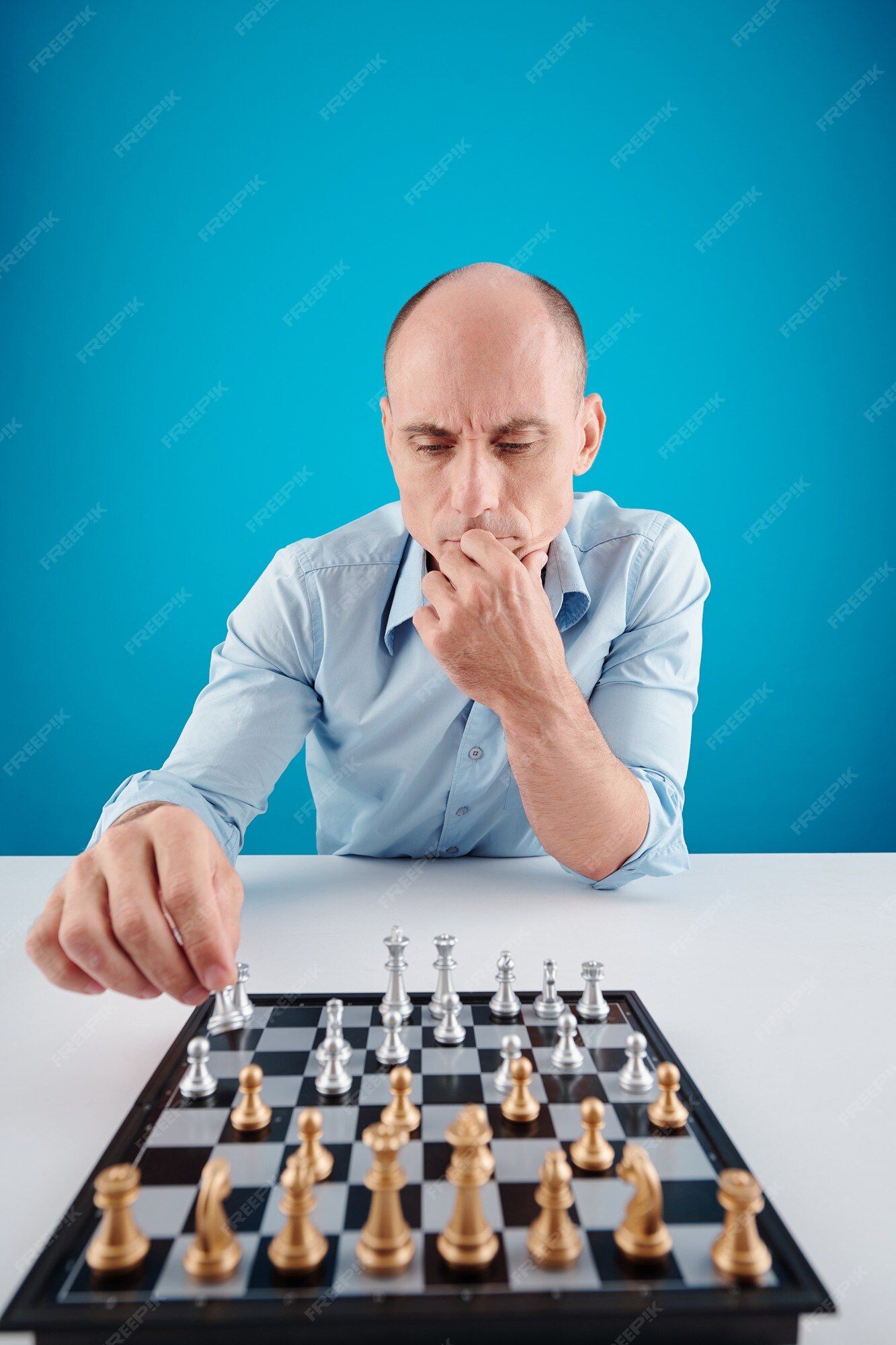 man studying the next chess move Stock Photo - Alamy