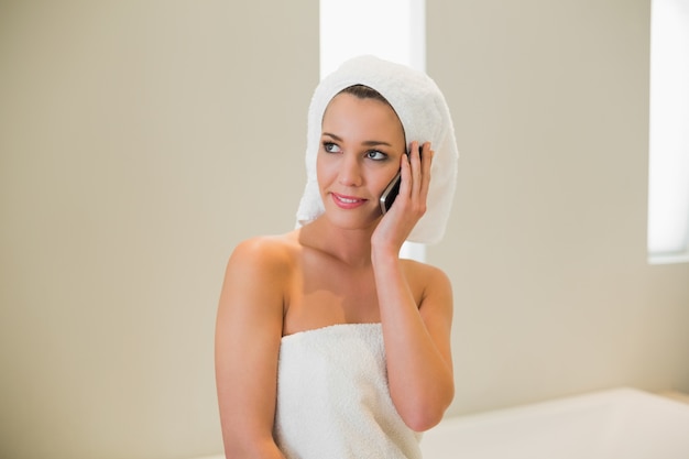 Pensive natural brown haired woman making a phone call