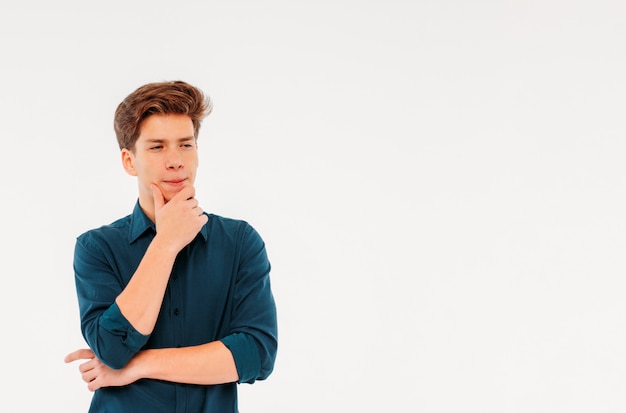 Pensive teenager student on white background