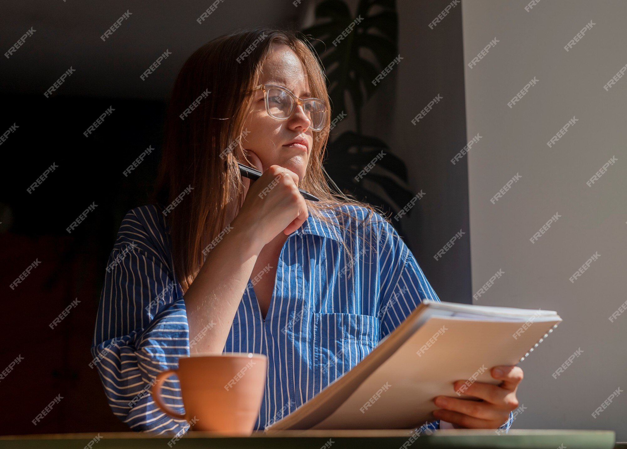 Premium Photo  Pensive woman sitting at table while thinking