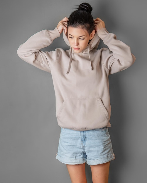 Pensive thoughtful young girl wearing sweatshirt with hood