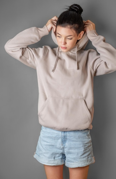 Pensive thoughtful young girl wearing sweatshirt with hood