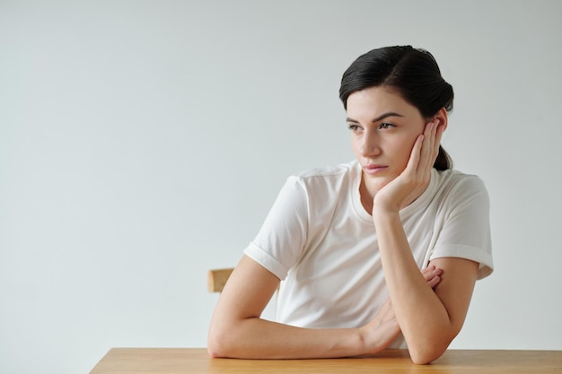 Pensive Woman Leaning on Desk