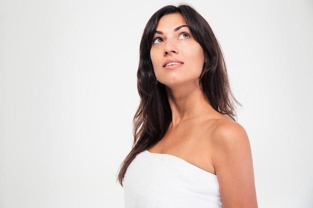 Pensive woman in towel looking up