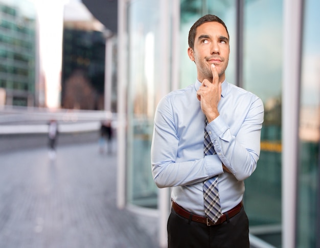 Pensive young businessman  posing