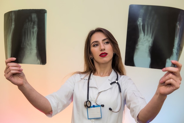 Pensive young doctor examining x-ray and making diagnosis. Medical concept