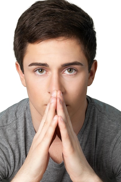 Pensive young teenage boy against white background