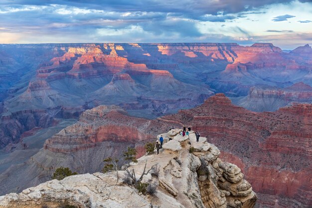 People admire the incredible sunset views of Grand Canyon National Park Northern Arizona USA