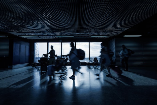 People at an airport terminal waiting for departure time motion blur shot