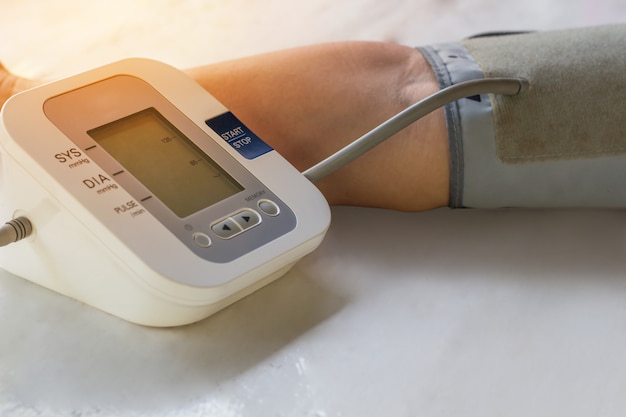 People are check blood pressure monitor and heart rate monitor with digital pressure. 