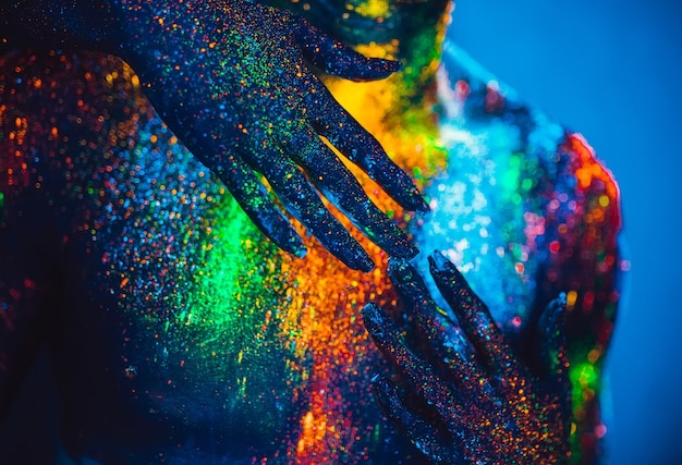 People are colored fluorescent powder. a pair of lovers dancing at a disco.