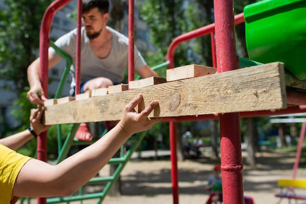 People are engaged in work with wooden boards closeup