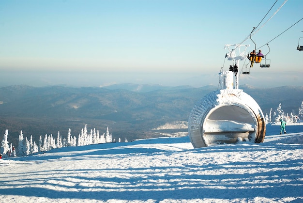 People are lifting on ski-lift in the mountains.