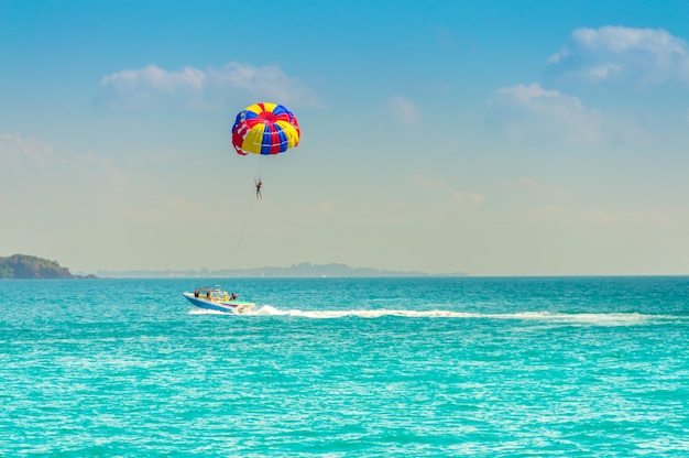 People are play Parachute in the sea