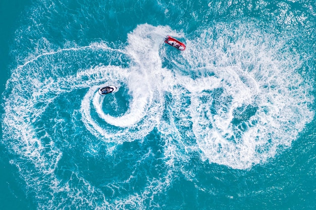 People are playing a jet ski in the sea Aerial view Top view amazing nature background Adventure