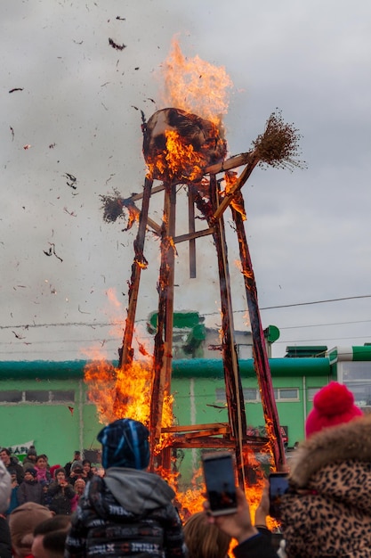 people are standing behind the fire, a burning effigy.