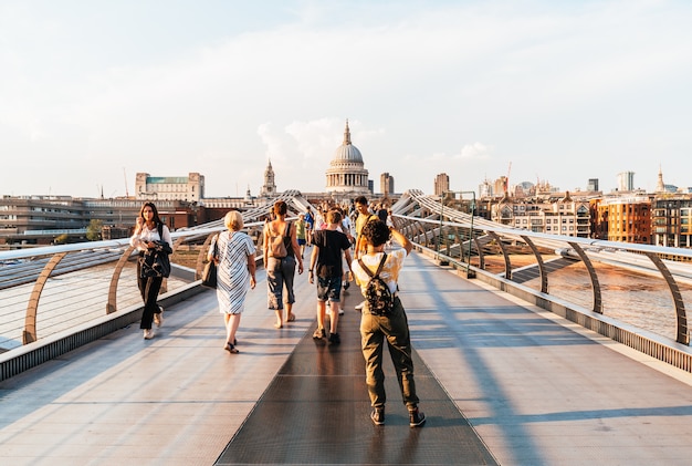 People are walking through Millenium bridge