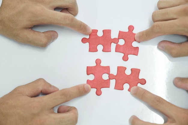 People assembling puzzles finding solution