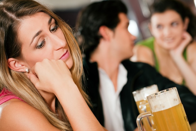 Photo people in bar, woman being abandoned and sad