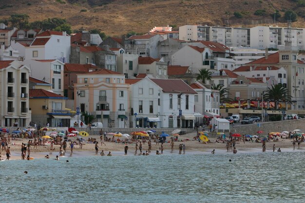 Photo people on beach against buildings in city