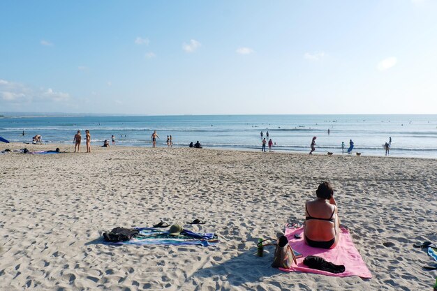 People at beach against sky