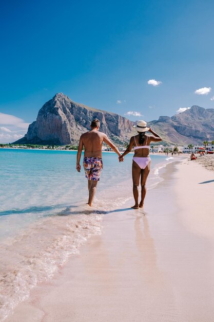 People on beach against sky