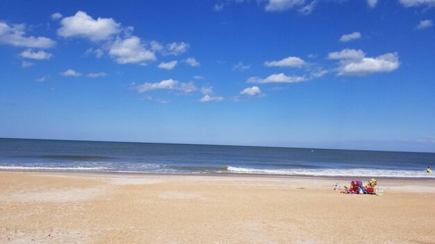 People on beach against sky