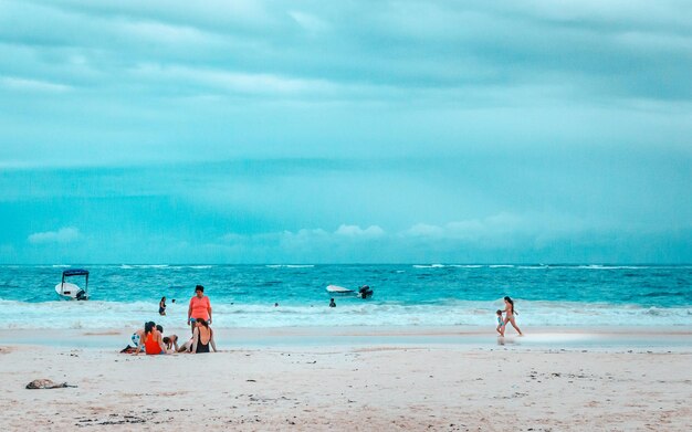 People on beach against sky